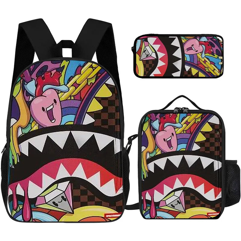A set of two black backpacks featuring a shark graphic cartoon print with pink and yellow accents.
