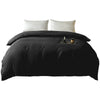 Black brushed duvet cover with white pillows and a candle on the bed
