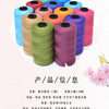 A collection of colorful 3-ply polyester knitting yarn spools in various shades including blue, green, orange, and purple.