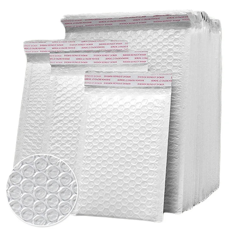 A stack of white padded bubble mailers with self-seal closures.