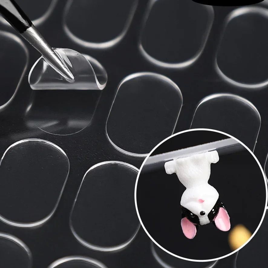 A small white mouse is placed on a transparent adhesive patch against a dark background.