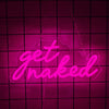 A neon sign shaped like the words get naked is illuminated in bright pink on a dark grid background.