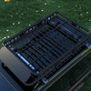 A close-up view of a black heavy-duty roof bar cargo basket installed on a vehicle, designed for a seamless fit.
