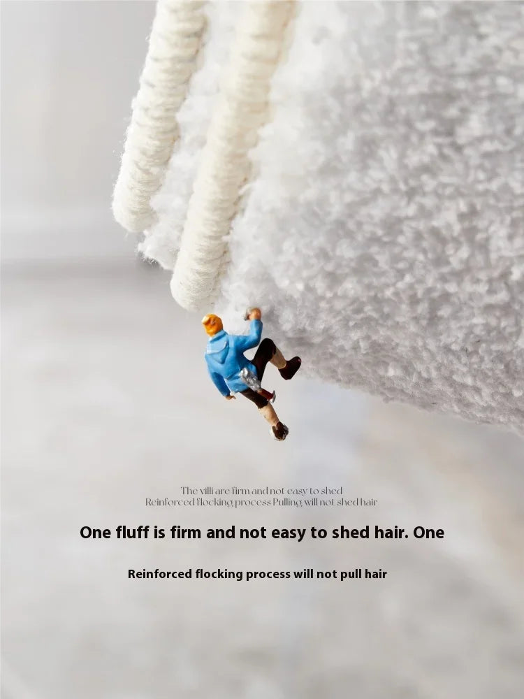 A person is shown jumping onto a thick, white, fluffy rug or mat.