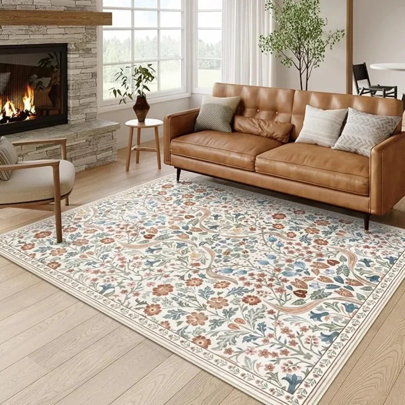 A vintage floral soft area rug featuring muted colors and botanical patterns in a living room setting.