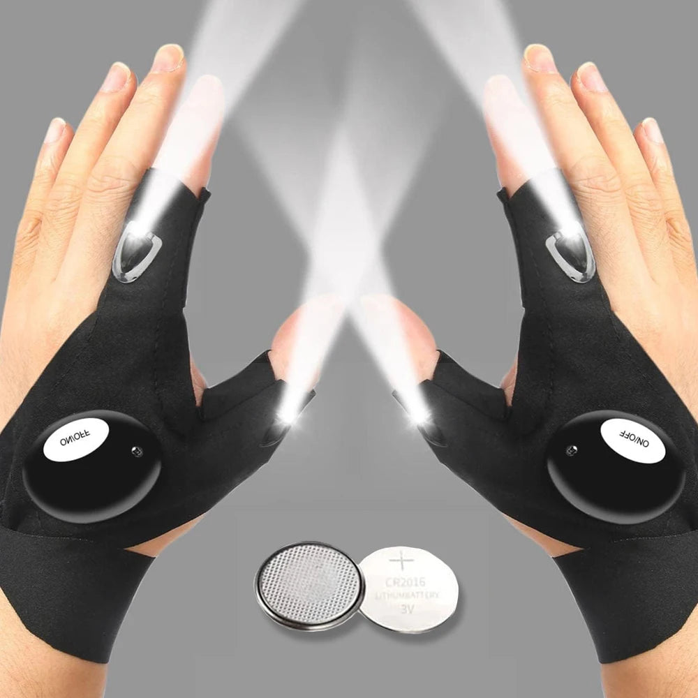 Pair of black waterproof LED half-finger gloves being used to illuminate a surface.