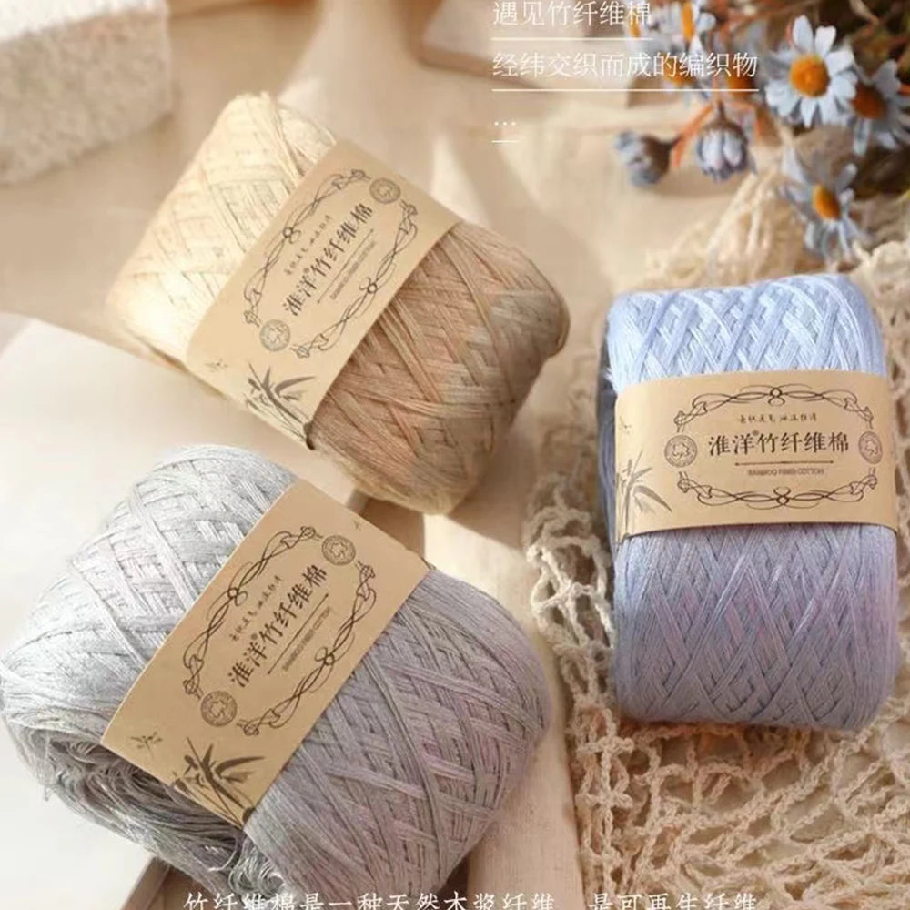 A stack of light blue yarn balls for knitting and crochet displayed on a textured fabric.