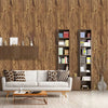 A living room interior featuring a beige textured wall, a light sofa, and wooden shelving units.