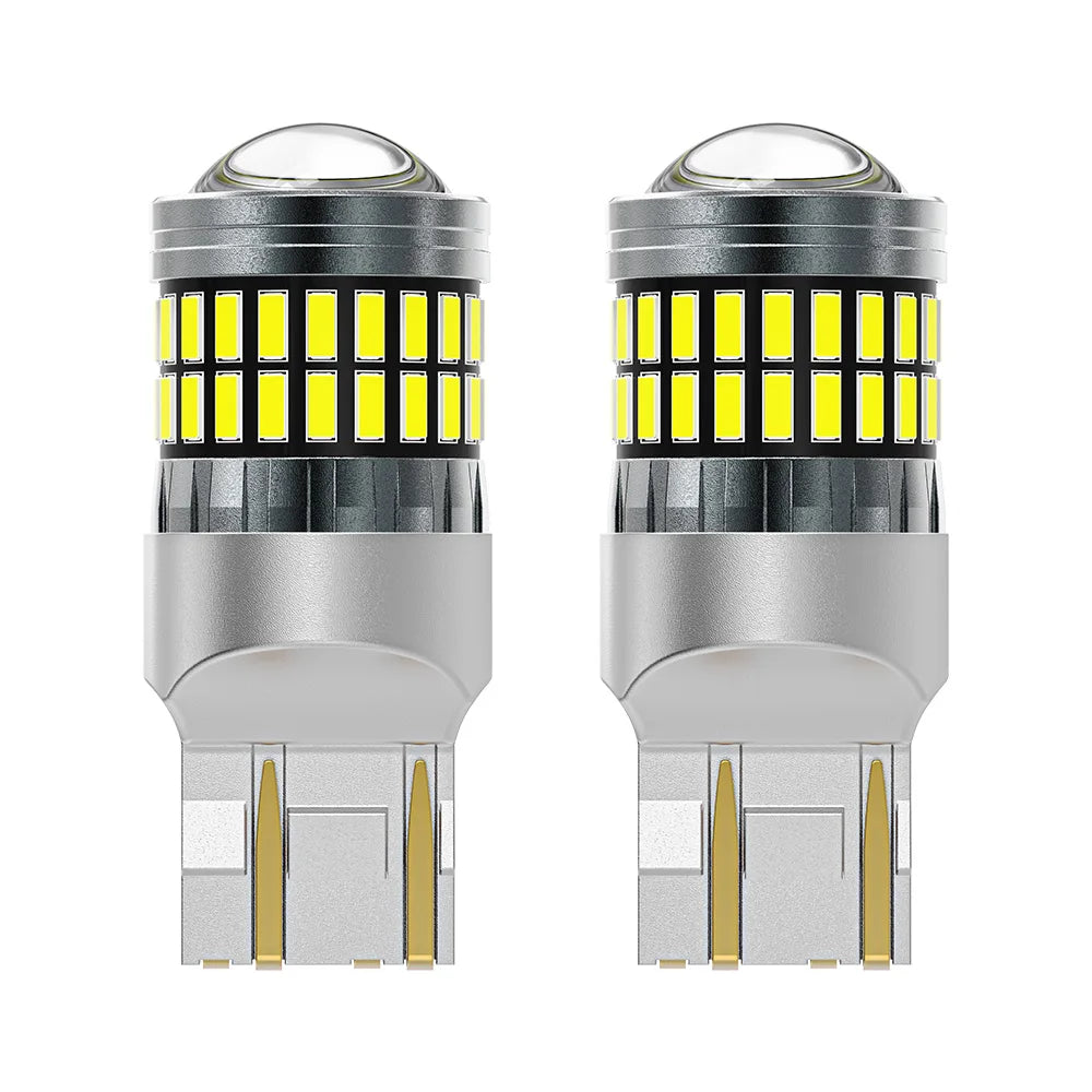 A pair of LED turn signal and reverse light bulbs with clear glass lenses and silver bases.