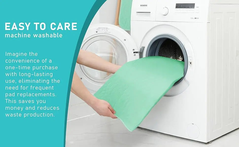 A hand places a green reusable waterproof underpad into the drum of a white washing machine.