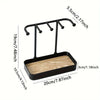 Black jewelry display rack featuring a drawer and a wooden base with hanging rods.