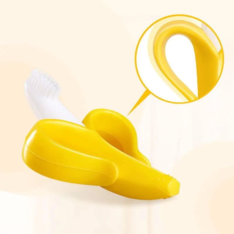 Yellow banana-shaped silicone baby teether and training toothbrush shown with a magnified view of the brush head