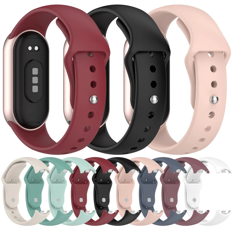Various silicone replacement straps for Mi Band watches in shades of red, black, and pink.