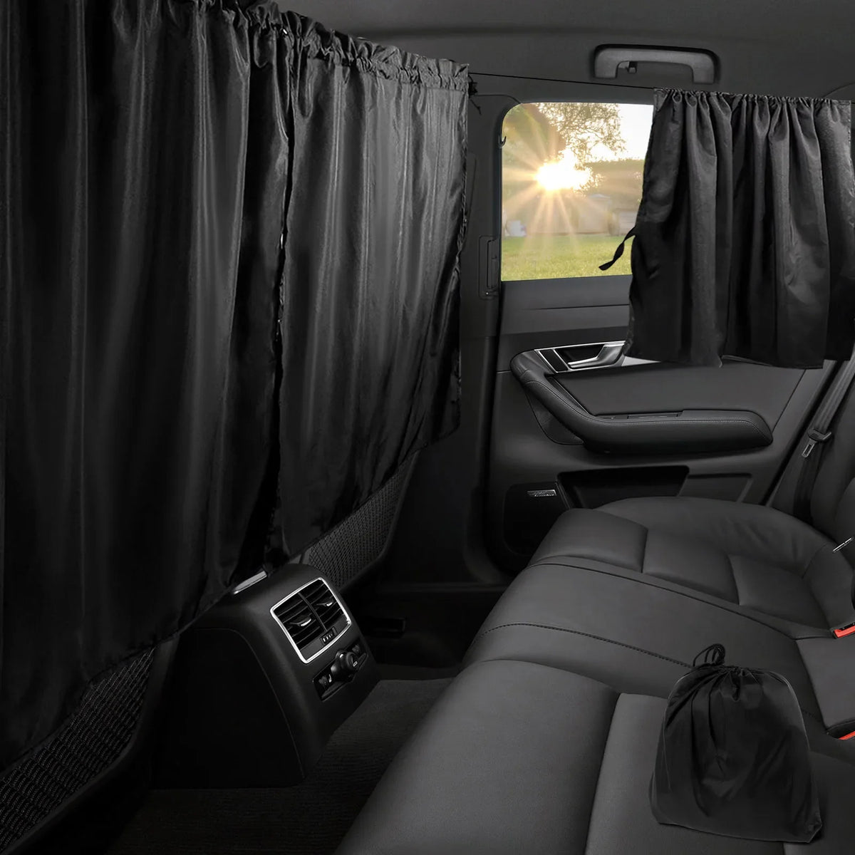 Black privacy curtains covering the rear window of a car, shown inside the vehicle cabin.