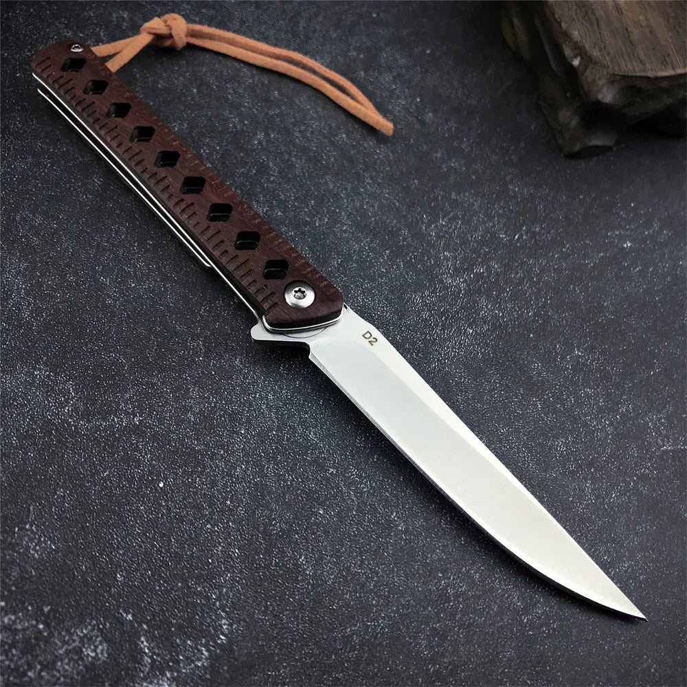Rosewood faltbare Taschenmesser mit silbernem Klinge und Ledergriff auf dunkler Oberfläche.