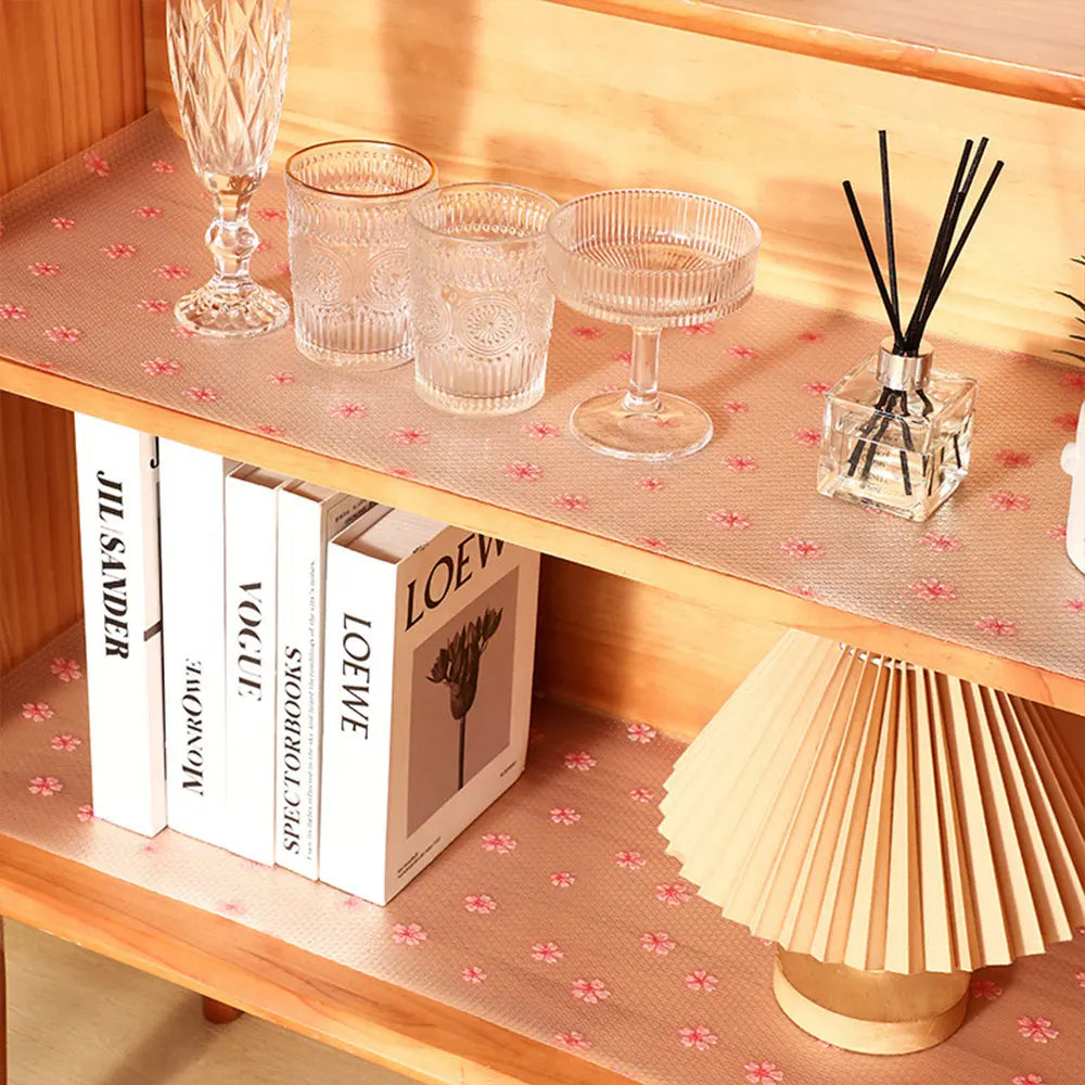 A wooden shelf displays glassware, books, and a decorative lamp.