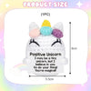 A white crocheted unicorn doll with a yellow horn and pink ears, featuring a positive unicorn message.