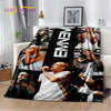 A black and white throw blanket featuring images of Eminem and 2Pac hip-hop icons.