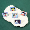 A collection of enamel pins featuring characters from SpongeBob SquarePants and Captain Patrick Star displayed on a white roc