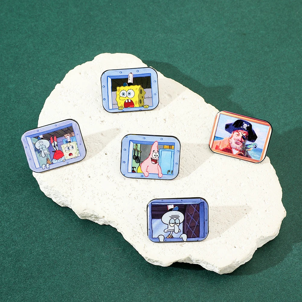 A collection of enamel pins featuring characters from SpongeBob SquarePants and Captain Patrick Star displayed on a white roc