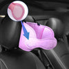 A pink car seat head support strap is shown inside a car seat, highlighting the fabric and attachment point.