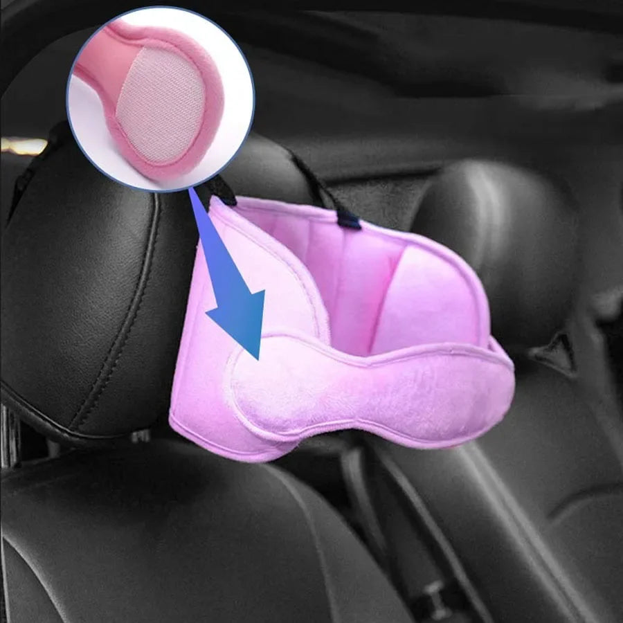 A pink car seat head support strap is shown inside a car seat, highlighting the fabric and attachment point.