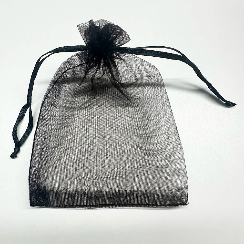A sheer black organza drawstring bag with a black tassel, displayed against a white background.