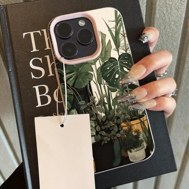 A pink monstera pattern phone case for an iPhone is shown in a black sleeve.