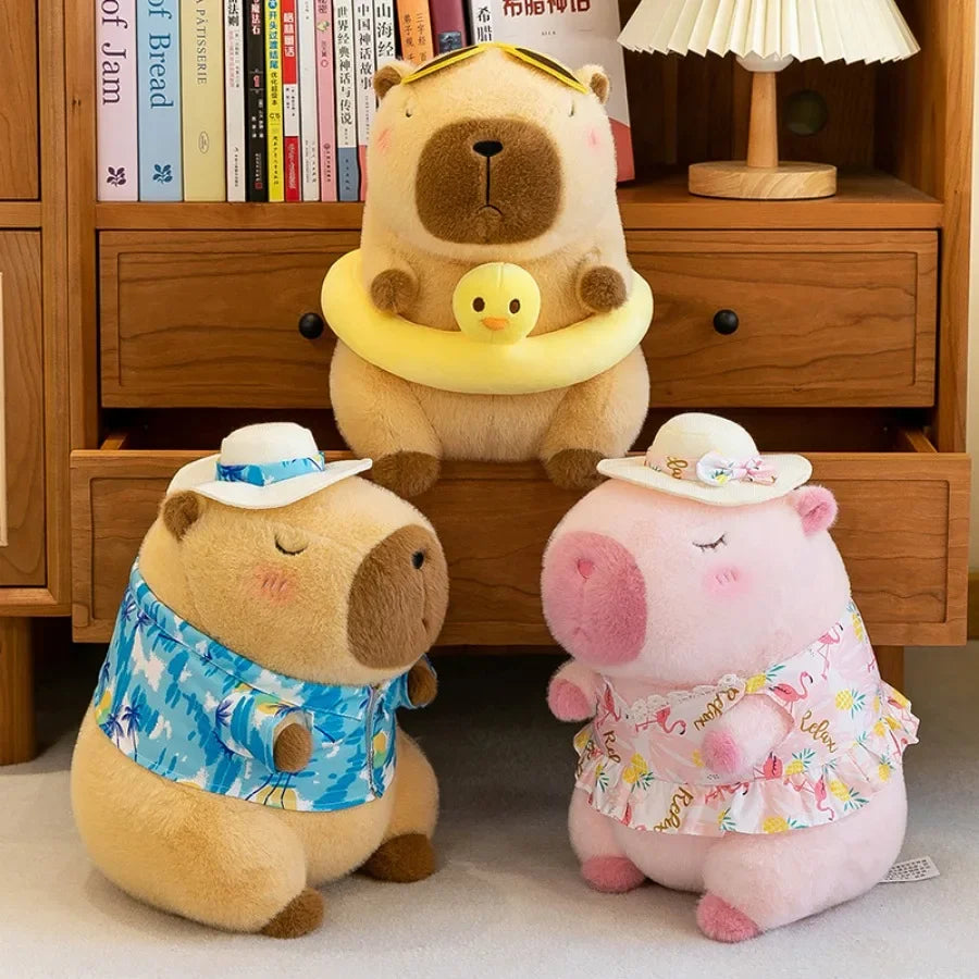 A plush toy of a capybara wearing a yellow duck swim ring, sitting in front of a wooden cabinet.