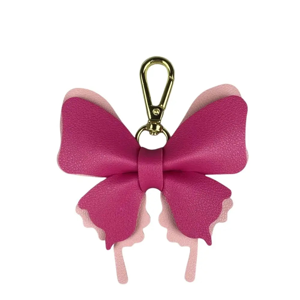 A pink PU leather butterfly bag charm with a gold-tone metal loop.