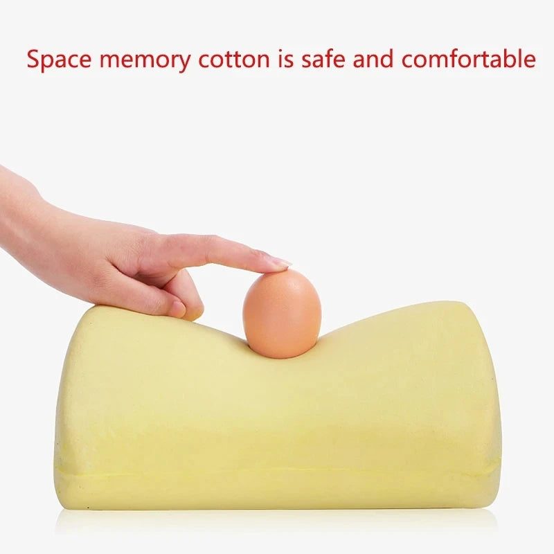 A hand is placing an egg on a yellow memory foam neck pillow.