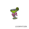Green cocktail glass with lime garnish and pink ribbon embroidery
