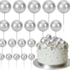 Ein Set von 20 silbernen Ball-Kektoppern auf weißen Stäbchen, präsentiert auf einer silbernen Platte.