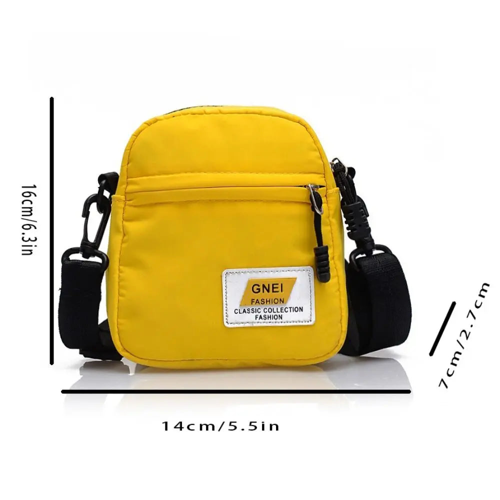 A yellow mini canvas crossbody bag with black strap and adjustable closure.