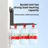 A black wall-mounted drying rack with three clear plastic bottles attached, demonstrating strong load-bearing capacity.