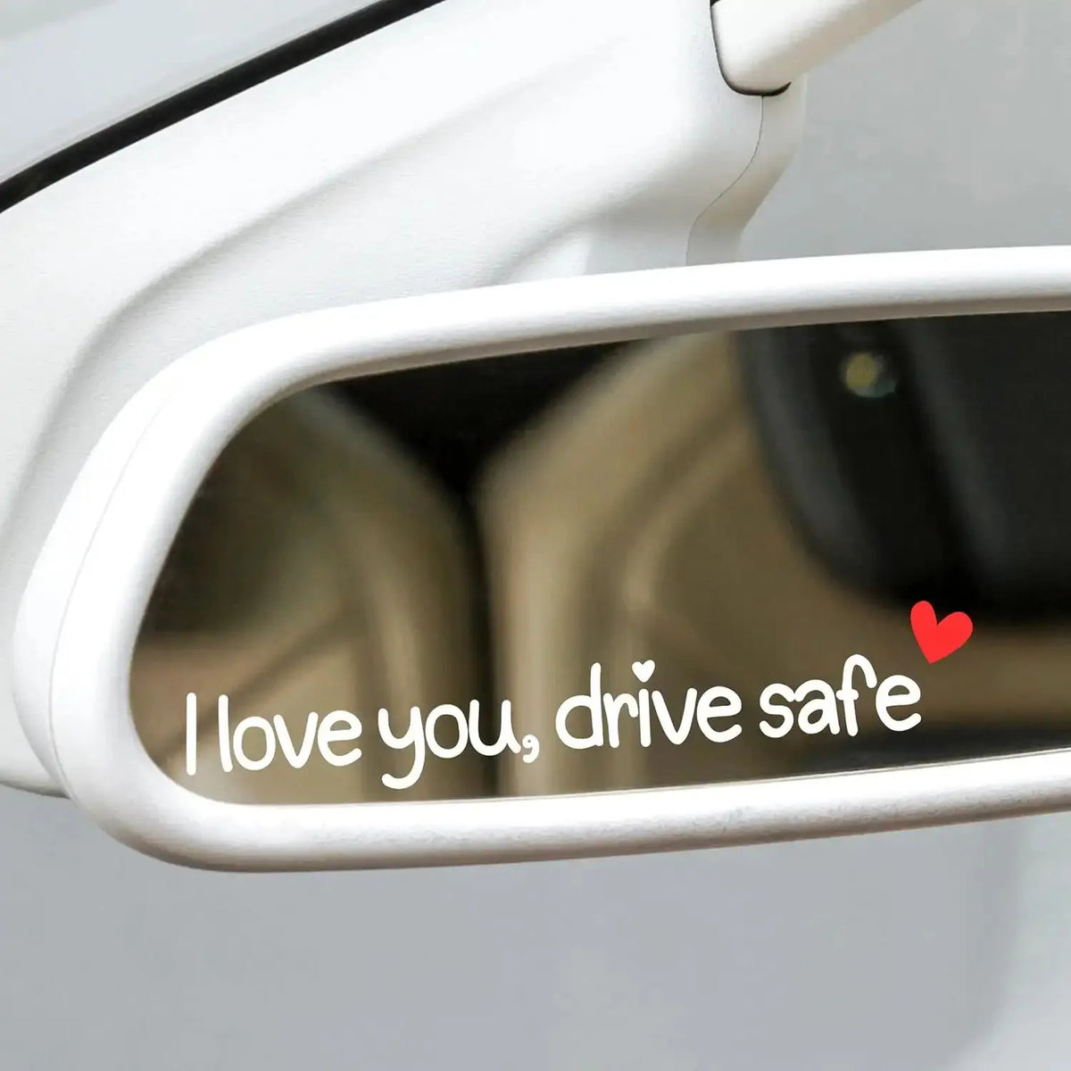 A close-up view of a car decal sticker set featuring the text I love you drive safe on a rearview mirror.