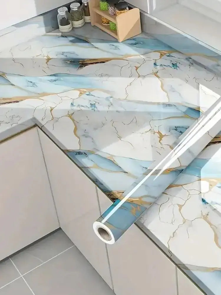 Marble contact paper featuring blue and gold veining used as a kitchen or bathroom surface design.