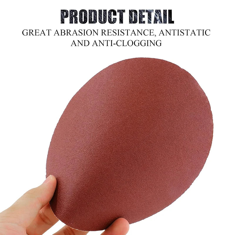 A hand holds a reddish-brown sanding disc for wood, metal, and stone.