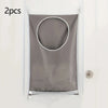 Two gray fabric laundry storage bags with circular openings are shown hanging on a white door.