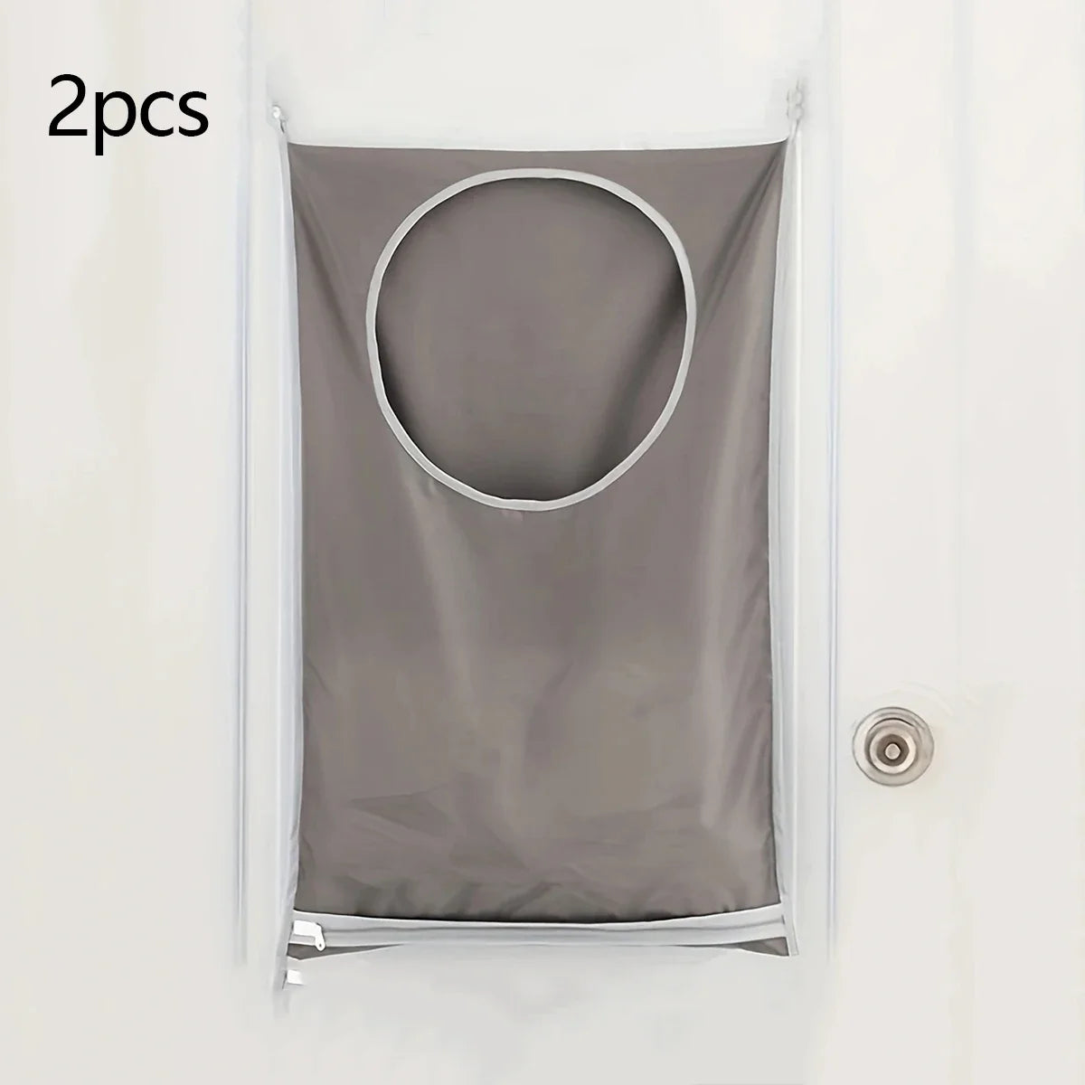 Two gray fabric laundry storage bags with circular openings are shown hanging on a white door.