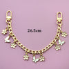A gold-colored chain necklace featuring small white flower charms and a lobster clasp, measuring 26.5cm.