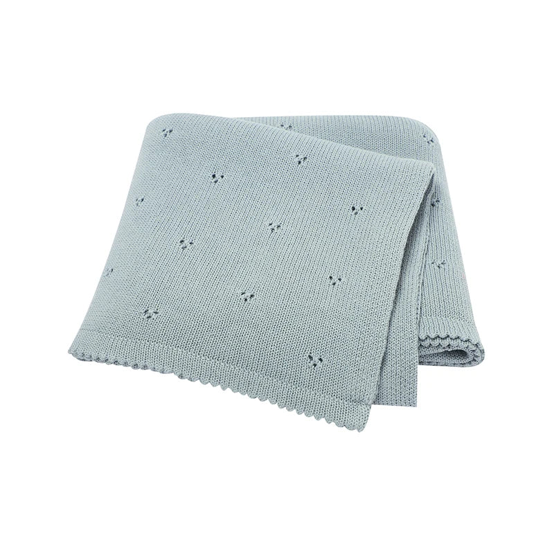 Light blue knitted soft cotton baby blanket with small embroidered patterns