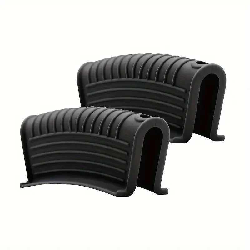 A pair of black heat-resistant silicone pan handle covers with ribbed texture.