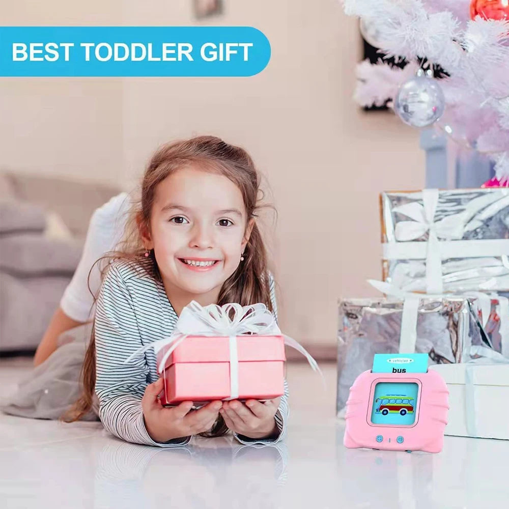 A young girl is holding a pink gift box and a pink bus-shaped learning toy for toddlers.