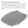 A gray silicone body brush with numerous small bristles is shown from above.