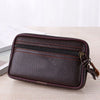 A dark brown men's multi-function PU leather waist bag with stitching and a leather strap resting on a wooden surface.