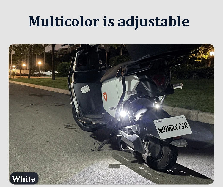 A white motorcycle is parked on a street, with a strobe light visible on the front.