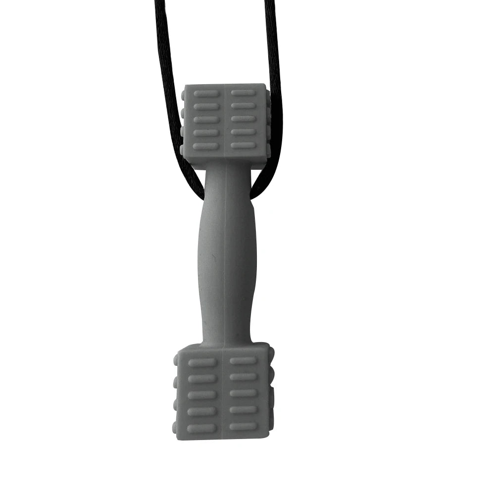 A gray silicone sensory chew necklace pendant with a black cord, designed as an oral motor teether for kids.