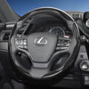 A close-up view of a black steering wheel with carbon fiber texture grips and controls inside a car
