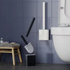 A wall-mounted toilet brush set with a silicone head is displayed against a dark gray tiled wall.